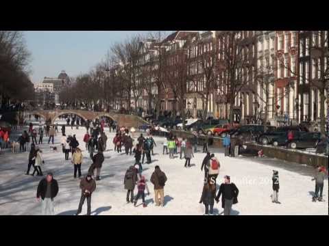 Ice skating on frozen canals in Amsterdam - Winter Travel in Holland