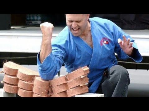 man breaks stone with bare hands  . incredible strength.  motivation.